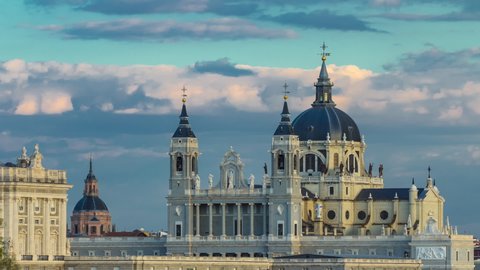 Madrid, Spain skyline timelapse at Santa Maria la Real de La Almudena Cathedral and the Royal Palace at sunset time.