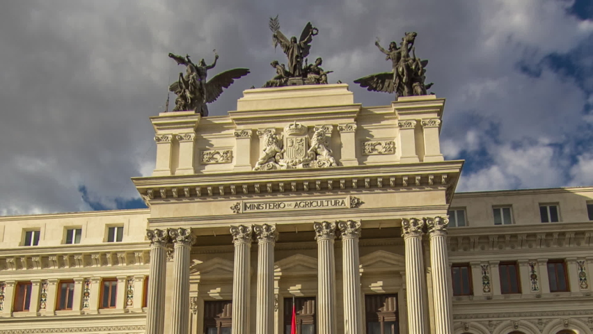 Government palace facade the Ministry of Agriculture building (Ministerio de Agricultura) timelapse hyperlapse with traffic. Placed close to the Atocha railway station in Madrid, Spain.