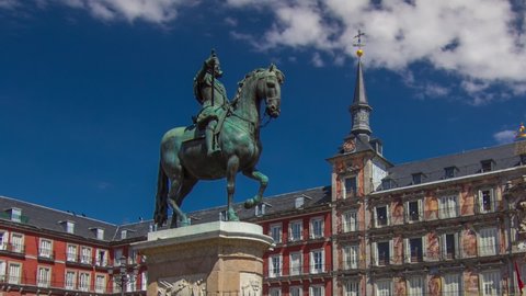 Statue of Philip III timelapse hyperlapse at Mayor plaza in Madrid in a beautiful summer day with cloudy sky, Spain