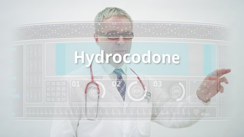 Doctor scrolls to IBUPROFEN generic drug name on a touchscreen display