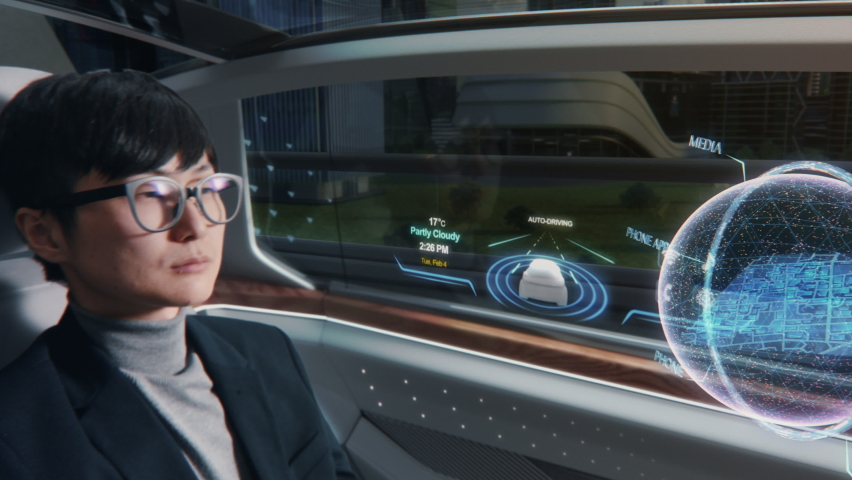 Futuristic Concept: Japanese Businessman Checking Arrival Location on an Interactive Augmented Reality 3D Navigation App while Sitting in on the Back Seat of an Autonomous Self-Driving Car with VFX. Royalty-Free Stock Footage #1067208061