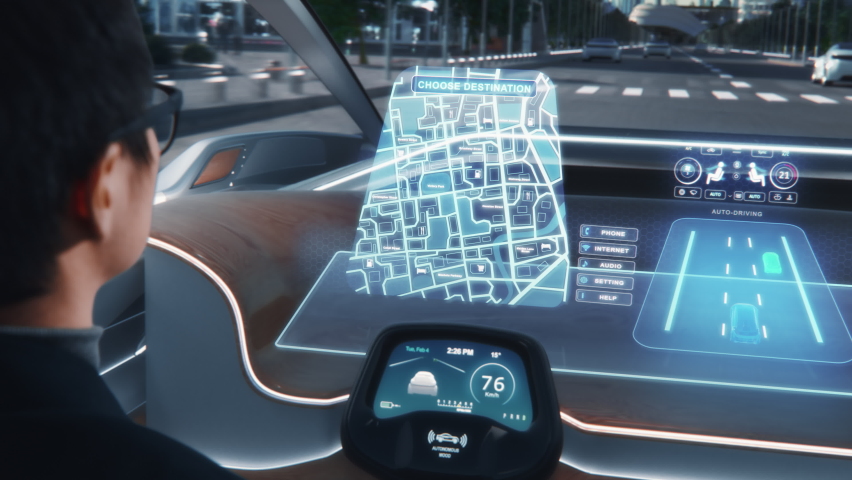 Futuristic Concept: Stylish Businessman Setting Location on an Interactive 3D Navigation App on an Augmented Reality Dashboard while Sitting in an Autonomous Self-Driving Zero-Emissions Electric Car. Royalty-Free Stock Footage #1067208067
