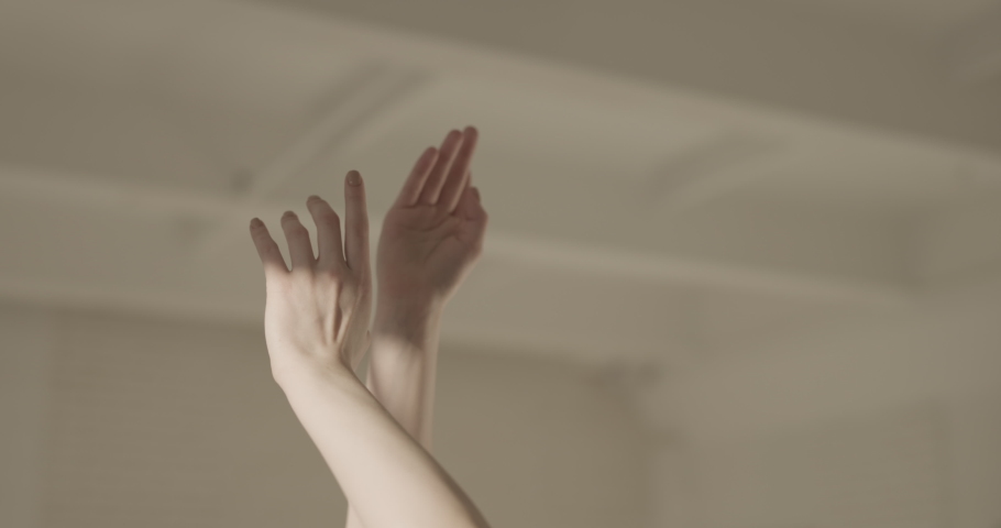 Female ballet dancer performing, moving her hands. Close-up shot of beautiful hands of choreographer in white studio - art, aesthetic 4k footage | Shutterstock HD Video #1067210515