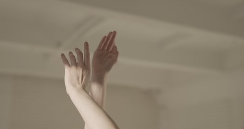 Female ballet dancer performing, moving her hands. Close-up shot of beautiful hands of choreographer in white studio - art, aesthetic 4k footage