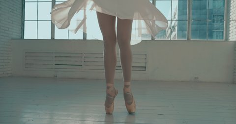 Talented young choreographer dancing ballet in white studio. Pretty graceful ballering doing elements of classical ballet - arts concept 4k footage