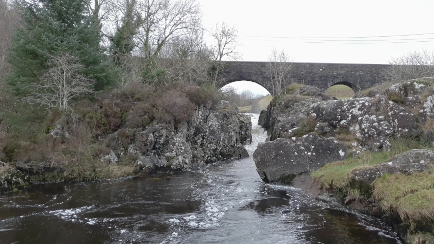 A rocky highland pool under a bridge on a Scottish River, the Water of Ken, in winter, Galloway, Scotland