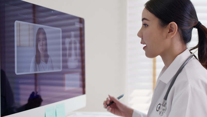 Attractive beautiful asia chinese female doctor video conference call online live talk follow up remotely in medical coronavirus result with patient at office. Online telehealth telemedicine service. | Shutterstock HD Video #1067226088