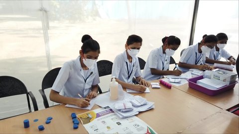 MUMBAI-INDIA - January 16, 2021:  A medical worker writes down the names of healthcare workers as they arrive to get a Covid-19 coronavirus vaccine at the Cooper Hospital.