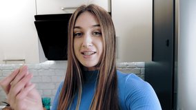 healthy lifestyle. Vlogging and social media. online nutritionist. beautiful woman shoots video about healthy food in kitchen at home. she stands in front of camera and talking about healthy diet.