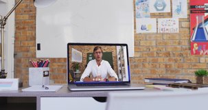 Caucasian male teacher displayed on laptop screen during video call. Online education staying at home in self isolation during quarantine lockdown.