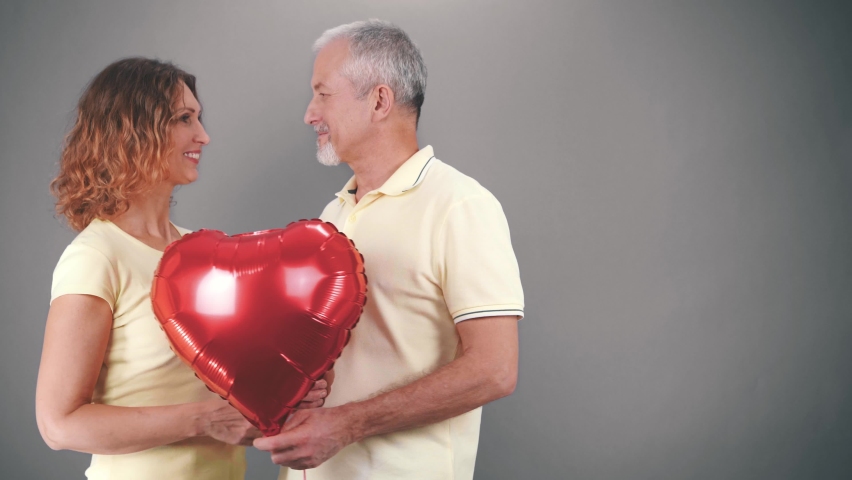 Mature couple in casual attire celebrating Valentine