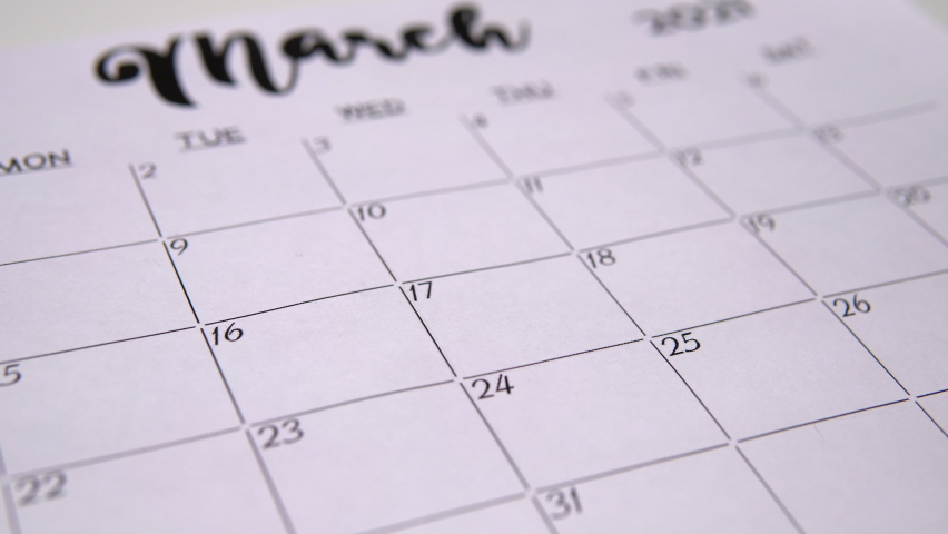 The girl marks the day for work on the calendar.