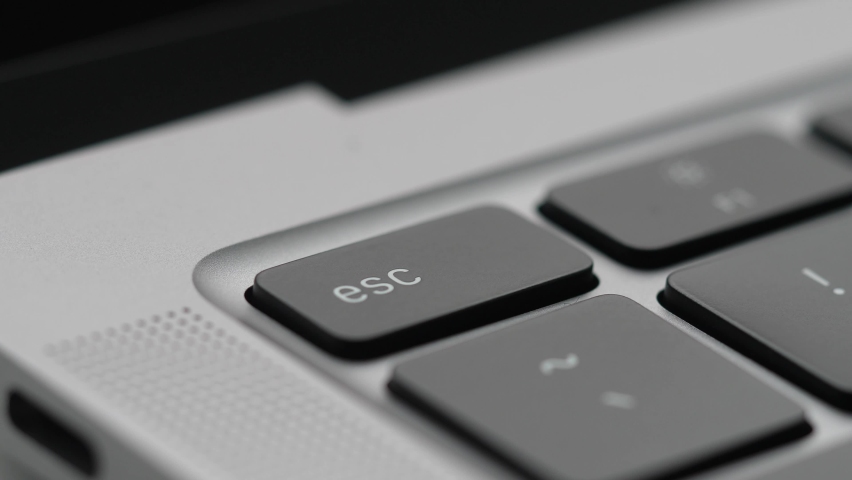 Finger Pressing the Escape key on a Laptop Computer Keyboard