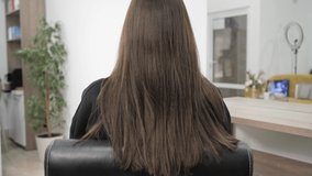 Demonstration of the brunette's hair before straightening it. Brittle tangled brunette hair. High quality 4k footage