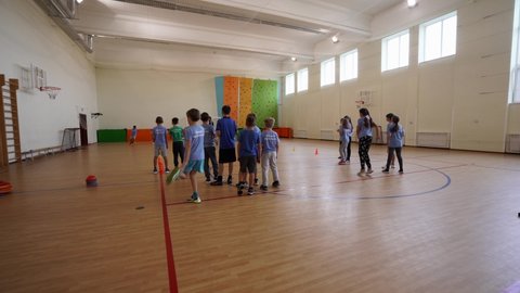 Sofievskaya Borschagovka, Kiev region, Ukraine - October 2020: Adolescent children play moving games and relay races in a physical education class at a private school.