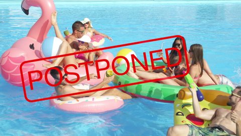 SLOW MOTION, CLOSE UP: Group of friends will have to postpone their summer pool parties due to the global coronavirus quarantine. Playful tourists enjoy a sunny summer day at a large private pool.