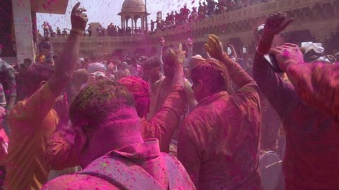 People celebrating holi festival with colors. holi is a festival of India. It is festival of colors and Joy. It is also called as Dhuleti. Nand gaon, Uttar Pradesh, India - March 5th 2020