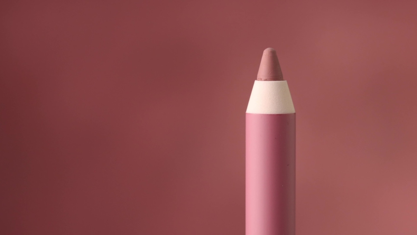 closeup of pink lip pencil rotate and moove from right to left
