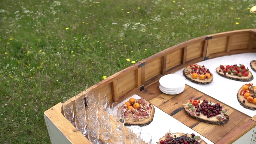 wedding buffet in nature on a table in the form of a boat