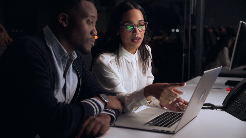 Mixed race co workers working late at night on collaboration project brainstorming ideas for topics Royalty-Free Stock Footage #1067257576