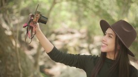 Young woman trekker is making selfie  in the woods, holidays and traveling concept.
