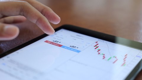 Investors are trading securities. Using smartphones and computers
