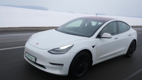 MINSK, BELARUS - JANUARY 20, 2021: Tesla Model 3 drives on a highway. 