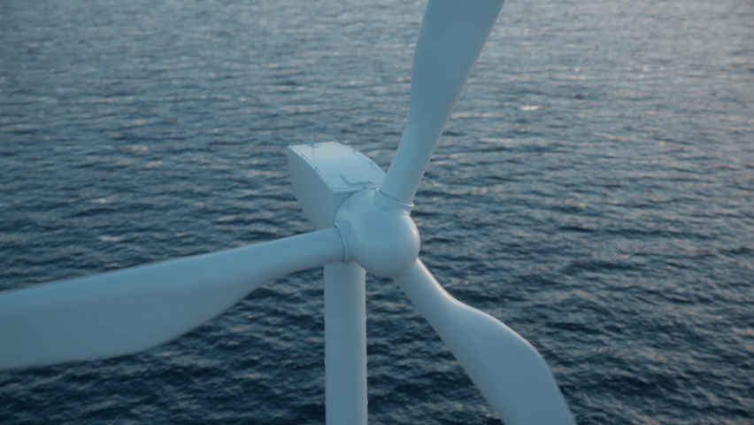 Camera pulls back to show an aerial view of a long row of offshore wind turbines in the sea against low sun. Green and renewable energy concept. Realistic high quality 3d animation. | Shutterstock HD Video #1067268409