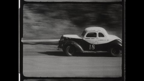 1940s Baldwin, GA. Tommie Irvin races his Stock Car at Banks County Speedway in early NASCAR Race. His famed #18 Stock Car Crashes and Rolls Over. 4K Overscan of Vintage Archival 16mm Film Print.  