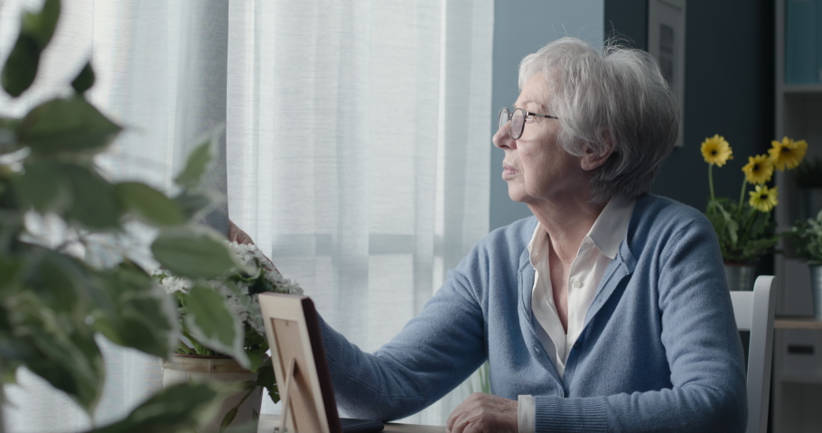 Lonely senior woman remembering her husband, she is coping with grief and loss | Shutterstock HD Video #1067271958