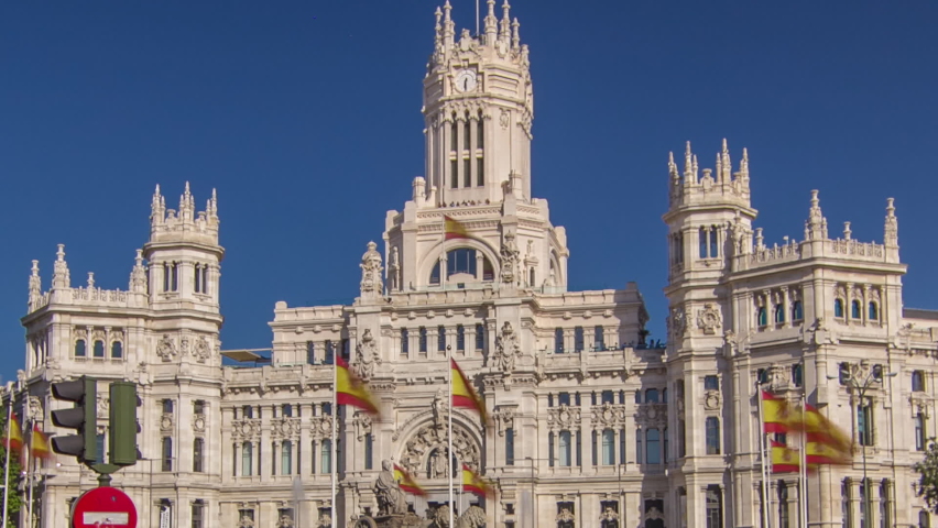 Cibeles fountain and cars traffic at Plaza de Cibeles in Madrid in a beautiful summer day, Spain timelapse hyperlapse