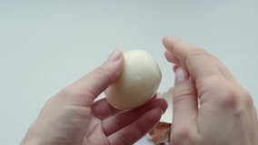 Hands peel eggshells from boiled eggs, close-up. Hard boiled egg opening, protein source. Healthy breakfast. Easter concept - Powered by Shutterstock - Get 15% off with code: PIKWIZARD15