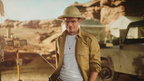 Portrait of Handsome Male Adventurer Posing and Looking at Camera. Stylish Great Archaeologist Standing with Ancient Civilization, Fossil Remains Archeological Site, Forgotten City in Background