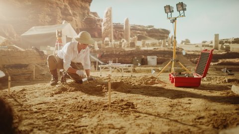 Archaeological Digging Site: Great Female Archeologist Work on Excavation Site, Cleaning Cultural Artifacts with Brush and Tools. Discovery of Ancient Civilization Temple, Architecture, Fossil Remains