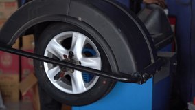 Counterbalance car tires in automobile service, automobile car machine repair tyre for checking for safety dirve on road, close up wheel for balance to transport, tyre free rotate tast control