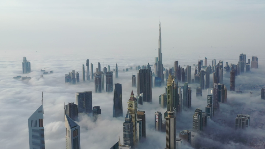 Aerial birds eye view of Dubai city urban futuristic skyline during fog | Shutterstock HD Video #1067295058