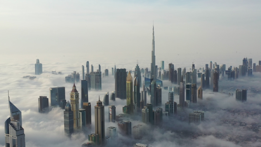 Aerial birds eye view of Dubai city urban futuristic skyline during fog; panning shot of Dubai  | Shutterstock HD Video #1067296051