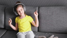 Cute Girl Kid Listens To Music Learns a Foreign Language Learns Remotely.