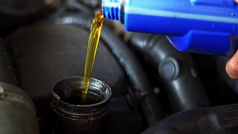 Motor Synthetic Oil Pouring To Car Engine. Synthetic Oils for Protecting Cars Engine Footage.
