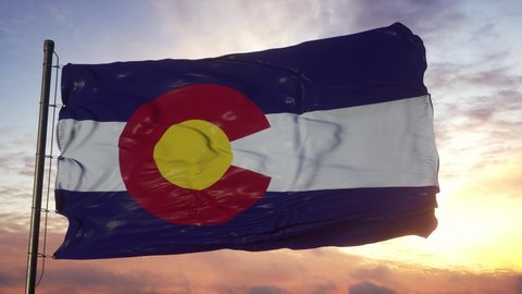 Flag of Colorado waving in the wind against deep beautiful sky at sunset
