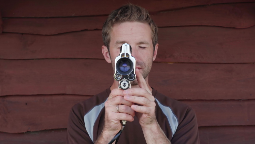 A young man makes a video on an old retro camera.