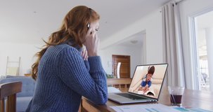 Caucasian female teacher using laptop and phone headset on video call with schoolboy. Online education staying at home in self isolation during quarantine lockdown.
