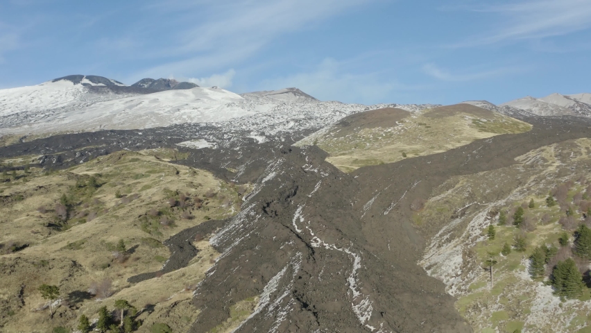 The Etna volcano seen from Piano Vetore with lava flow, the summit craters covered with snow in autumn. Sicily Italy.