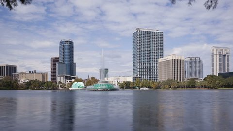 ORLANDO, FL, USA - OCT 30, 2014: 4K Time lapse Orlando Lake Eola in the morning with urban skyscrapers and clear blue sky.


