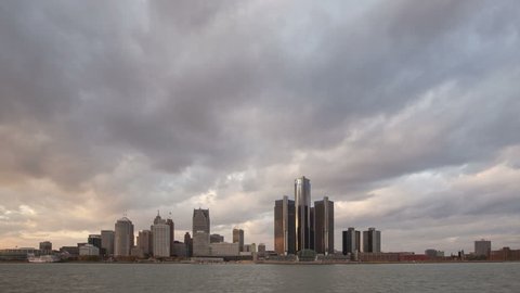DETROIT, USA - NOV 07, 2013: 4K Time lapse of Detroit city waterfront and skyline at sunset in twilight with clouds passing by 
