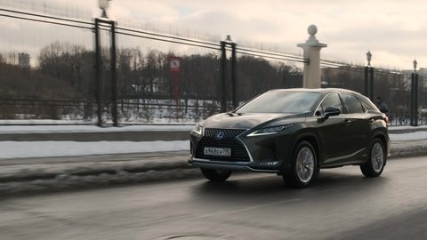 Moscow, Russia - CIRCA 2020: Nice footage of Lexus RX green big SUV drive road. Car drive on highway.