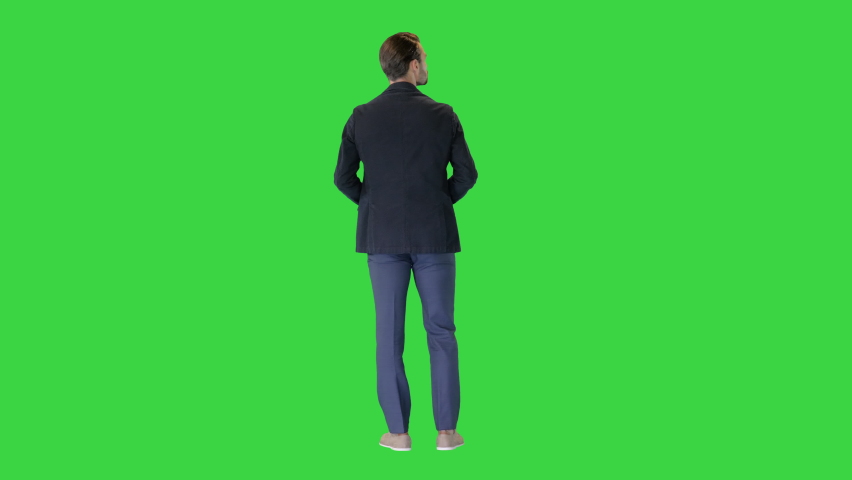 Confident businessman standing with hands on hips looking around on a Green Screen, Chroma Key. | Shutterstock HD Video #1067343502