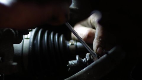 a mechanic unscrews the steering tips for replacement during vehicle maintenance