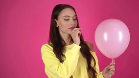 slow motion shoot of young woman piercing with needle pink air balloon and showing surprised emotion - Powered by Shutterstock - Get 15% off with code: PIKWIZARD15