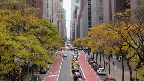 Manhattan, New York,USA - November 7. 2019: Heavy Traffic in NYC 42nd Street. Panning up to Chrysler Building from busy Street to Skyscraper